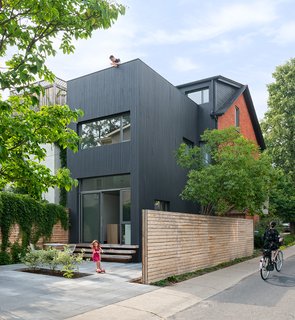 30 All-Black Exterior Modern Homes - Photo 22 of 30 - "Sustainability is very important to us," lead architect Heather Dubbeldam says. "It is easy to design with passive systems, to use passive sustainable principles to influence the design and layout of the house." Her team reduced the need for air conditioning and artificial lighting through carefully positioned doors and windows that draw in natural light and breeze. New insulation, low-flow plumbing fixtures, and low-energy lighting also minimize the homeowners’ dependence on utilities.