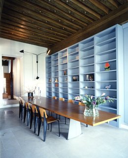 Francesca Molteni writes, "A table, a window, a royal square, statues and horses. In Paris, Place des Vosges, Doriana and Massimiliano Fuksas’s home. Original Jean Prouvé furniture, and masses of artworks, from Fontana to Paladino. On the threshold, antique warriors stand guard over the house and protect it, like custodians awaiting the return of its traveling architects."