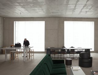 "First his studio, then his home. David Chipperfield chose Berlin, after the city commissioned him to rebuild the Neues Museum in 1997. It is in the same neighborhood, Mitte. In the courtyard that contains both his house and his studio, Chipperfield also designed a canteen, a place where locals meet. The house is built of concrete, with large windows overlooking the street and the courtyard. It contains a few ’50s and ‘60s Italian furnishings, and two colours. The green of a velvet sofa and the orange of a bookcase that divides the space between the kitchen and the sitting room." 