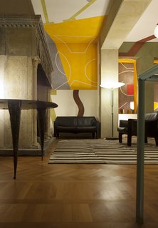 Mario Bellini loves Milanese urban culture, the city. His home, in a C19th building reworked by Piero Portaluppi, is designed around a large 9 metre tall library/staircase, which runs through and across it like a telescope. The books, artworks and objects make it reminiscent of Antonello da Messina’s painting of St. Jerome’s study. He is about to embark on a design for a white cube, his new home. That is his dream. 
