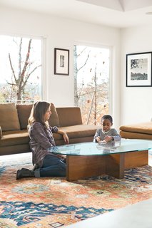 Birdsall plays with her son Atticus in the living room next to a Charles sofa from B&B Italia. Formwork also designed the coffee table—fitting, since the architects come from strong fabrication backgrounds.