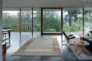 The couple brought most of the house’s furnishings from their previous home, including the living room’s hand-knotted South Persian Gabbeh that belonged to Philip Heid, Ted’s father. Philip put in the pond, beyond, when he bought the property.