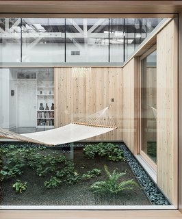 This Light-Filled Industrial Renovation Plays Host to Live Music - Photo 2 of 11 - The living areas and an office are arranged in an open layout around a central atrium that is open to the outdoors.