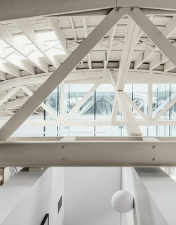 This Light-Filled Industrial Renovation Plays Host to Live Music - Photo 7 of 11 - Architects William Neburka and Carrie Strickland set off some spaces with walls that stop shy of the bowstring trusses to preserve an overall sense of openness.