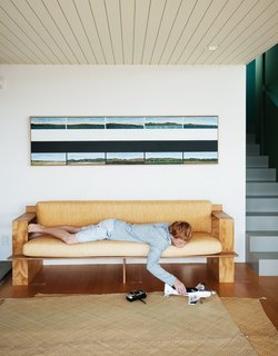 Bach to the Beach - Photo 4 of 30 - Will relaxes on the sofa Gerald designed, below a painting by Gary Freemantle.