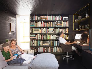 In the den, Lara and Cal read a Hardy Boys mystery on the Flexform Groundpiece sofa by Antonio Citterio while Chris works in his "office." The cozy room where the family spends much of their time once housed the kitchen.