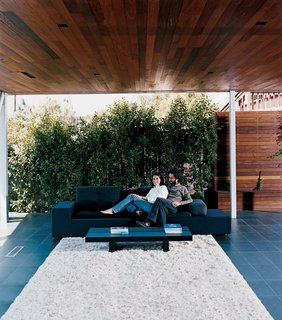 Sebastian and Maricarmen take in the scenery from the comfort of their exposed living room. The couple sits on a Polder sofa by Hella Jongerius for Vitra.