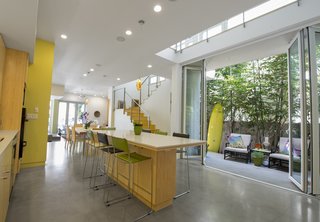 The kitchen and dining area opens onto a patio. Photo by Ken Pagliaro Photography.