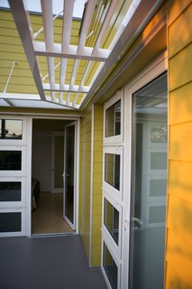 Lap siding, a brise-soleil awning and white accents are reference the architectural vernacular of this coastal part of Southern California. Photo by Ken Pagliaro Photography.