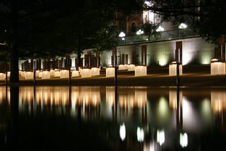 10 Inspiring Modern Memorials - Photo 5 of 10 - 5. Oklahoma City National Memorial & Museum (Oklahoma City, United States): Designed by Hans and Torrey Butzer with Sven Berg<br><br>A grid of illuminated glass-and-bronze chairs, laid out in rows to represent which floors of the Alfred P. Murrah Federal Building each victim was during the bombing, light up at night, becoming beacons of hope. Two gates mark the edges of plaza and memorial; the 9:01 Gate (the last moment of innocence) and the 9:03 Gate (the start of the healing process). Photo by Jimx.