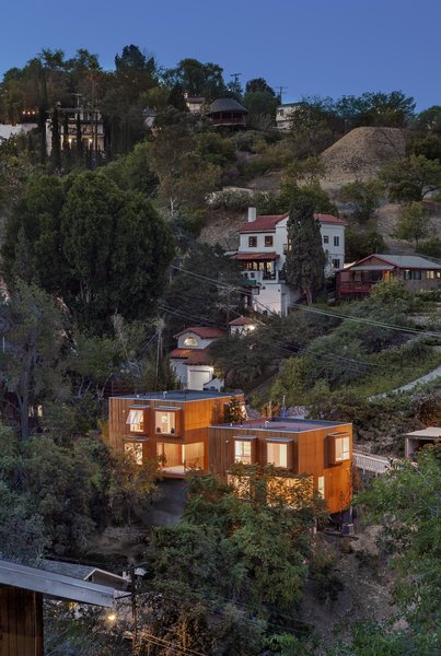 While the floor plans are identical, the two story cantilevered houses are offset and have subtle differences in size and height that, along with frosting on some of the windows, enable the owners to retain privacy.