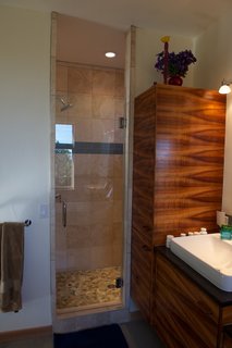 Mountaintop Modern - Photo 5 of 8 - The custom koa-veneer cabinetry also found a home in the master bathroom. Photo by Barry B. Doyle.