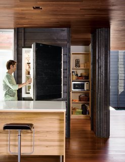 10 Stunning Ways to Use Black in Your Kitchen - Photo 1 of 10 - While most of the ground level is given over to the large open living and dining area, it also includes a small pantry, office, and Japanese bathroom. An integrated Sub-Zero refrigerator is almost unnoticeable behind its charred cedar cladding.