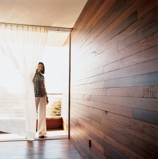 The Mariscals' bedroom opens out onto a small triangular patio. The exterior's ipe cladding also makes up the walls and floor of the master bedroom, further inviting the outside in.
