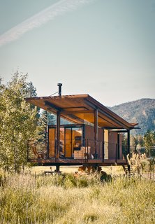 The steel-clad Rolling Huts designed by Olson Kundig Architects in Manzama, Washington, sit lightly on the land thanks to wheels that allow the tiny residences to "hover" above the site, optimizing views of the landscape. Photo by Derek Pirozzi.
