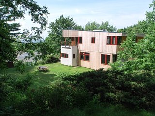 Named after a foothill between the agrarian Champlain Valley and the Green Mountains, the Chipman Hill house has an exterior of untreated local white cedar boards, fiber cement panels, corrugated sheet metal and translucent polycarbonate. Local pine and maple flooring and interior millwork, interrupted by areas of Vermont slate constitute the home's interior.