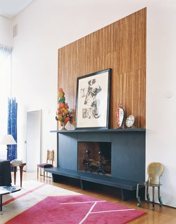 On the mantel above the fireplace, a Warhol collage is surrounded by a papier-mâché sculpture of no special provenance, a Vigliaturo glass piece, and a Picasso plate.