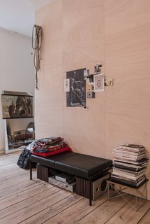 Salon of the Freunde von Freunden X Vitra ApartmentUnable to remove the center wall, architect Etienne Descloux instead created a wood-paneled centerpiece for the apartment.Photo by Steve Herud