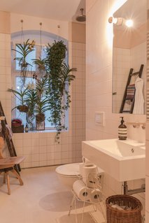 Bathroom of the Freunde von Freunden X Vitra ApartmentHanging plants and an open shower accentuate the bathroom’s light, airy layout. Sink by Alape, shower and fixtures by Dallmer and Dornbracht.Photo by Steve Herud