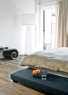 Modern Lilong House Renovation in Shanghai - Photo 8 of 11 - A Progetto Oggetto lamp by Marcel Wanders occupies a corner in the bedroom.