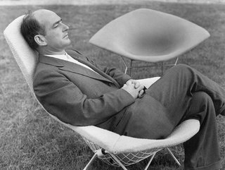 Design Classic: Bertoia Seating Collection - Photo 5 of 9 - Bertoia, here shown sitting in one of his famous chairs, designed in 1951 for Knoll.