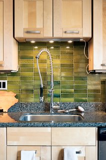 Second ComingIt took multiple weekend trips, but the couple finally landed upon enough green tiles to cover their kitchen wall. Overstock tiles and seconds can be purchased from Heath Ceramics in its Sausalito showroom. Though the surfaces aren't as uniformly colored nor as flat as first-run tiles, they offer a unique tone ans texture when the tiles are laid out.heathceramics.com<br><br>Don't miss a word of Dwell! Download our FREE app from iTunes, friend us on Facebook, or follow us on Twitter!