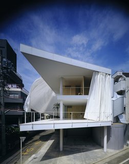 Curtain Wall House (Tokyo, Japan: 1995)<br><br>Taking the idea of an outer wall, and the concept of a shoji screen, to an extreme end, Ban wrapped the open triangular space of this contemporary home with large drapes, which provide an almost surreal quiet in and separation from the vast metropolis.<br><br>Credit: Forgemind Archimedia, Creative Commons