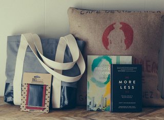 Plywood People's Billboard Bags are made from upcycled billboard materials and coffee bags by refugees who fled conflict-plagued countries for Clarkston, Georgia. Workers receive job training, English lessons, and income through the project. Photo courtesy of Plywood People.