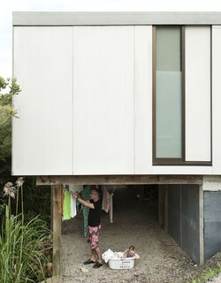 Beneath the house, Adam and Awa find ample space to hand the laundry to dry.
