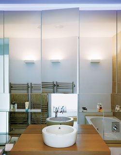 Bruce and Kirsty are obsessively tidy, so copious storage was a must. An entire wall in their bathroom opens to reveal a cabinet that is exactly the depth of a fat roll of toilet paper, and one of their kitchen cupboards was specially fireproofed in order to house that dastardly appliance, the toaster.