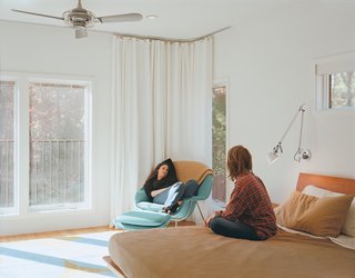 Kid Tested, Mothers Approved - Photo 6 of 8 - The narrow hallway separates an office and television room at one end of the house from Wexler and Zimmerman’s master suite, which sports an Emma Gardner rug and matching Saarinen Womb chair, made for Knoll, perfect for lounging.