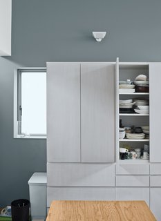White prefabricated cabinets and countertops make for a streamlined kitchen.