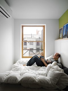 The bed takes up nearly the entire master bedroom, but it doesn’t make the space feel cramped. The wide window keeps the tiny box light.