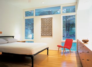 Jens Risom’s 1941 lounge chair for Knoll sits alongside custom-made cabinets in the Wilson’s master bedroom. Ken’s father, an archeologist, collected the pottery and wall hanging in the American southwest.