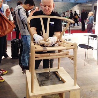 Milan Design Week: Day Three - Photo 1 of 8 - Carl Hansen & Søn show how the seat is woven on a Hans Wegner Wishbone chair.