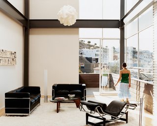 In the living room, mid-century classics are the foundation while art from the house’s "coming out" party by Enrique Ciapara adds some personality.