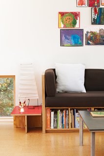 In the living room, an Akari lamp by Isamu Noguchi sits atop a coffee table Hale made and next to a collage of Maisie and Pippa’s paintings. Like most of the furniture in the house, the couch, coffee table, and side table were made by Hale or his close colleagues, often in his favorite material: plywood.