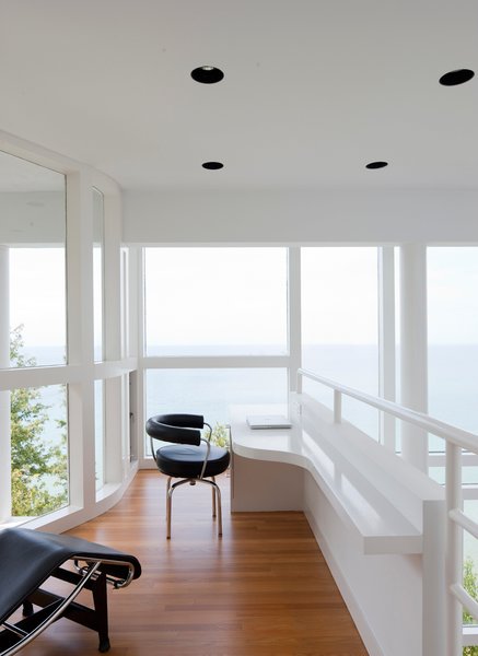 The office, which overlooks the main living space, is situated as if it's the prow of a ship.