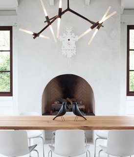 The dining space in this Atlanta abode features two Eames House Birds and a cuckoo clock from Diamantini & Domeniconi. Photo by Gregory Miller.