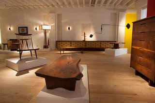 Exploring the process of George Nakashima Woodworker - Photo 1 of 4 - The exhibit includes the Shoki Collection (back left), the ASA-NO-HA Lamp (back wall), and an array of Nakashima originals.