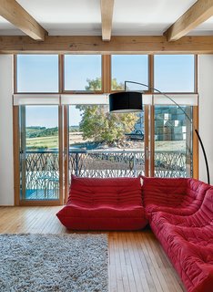 This Farmhouse is a Cor-Ten Steel-Clad Dream - Photo 3 of 11 - The lounge, with maple flooring from an old school in nearby Aberdeen, has a Togo sofa by Michel Ducaroy for Ligne Roset.