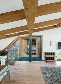 8 Beautiful Home Projects Using Reclaimed Wood - Photo 6 of 8 - Different types of reclaimed wood, each from different sources, steal the show in this residence in the Scottish countryside by Glasgow-based architect Andrew McAvoy of Assembly Architecture. Thick, deep oak beams were reclaimed and reused for structural elements, while the maple flooring was salvaged from an old school in the nearby rural village of Aberdeen. The reclaimed wood was a critical contributor to the goal of sustainability in the home.
