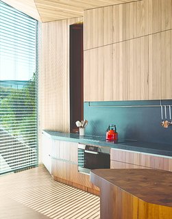 A Eucalyptus-Lined Oceanfront Home in Australia - Photo 5 of 9 - Wardle’s firm designed the end-grain butcher’s block (left), which serves as an end-of-day gathering point where their kitchen meets the dining area. "We were happy to let John go free and see what he came up with," the wife says. "He thought of things we would never have thought of, like the chopping board. He knew what we wanted."