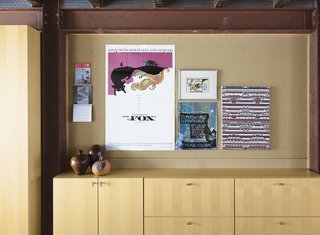 Family Home Renovation in Brooklyn - Photo 10 of 28 - Artwork hangs above the built-in storage in the English basement.