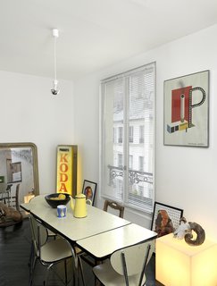 A simple poster with bold colors adds to the industrial character of this Paris abode. Photo by Céline Clanet.