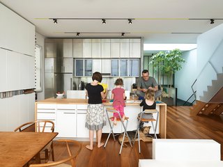 Just Redo It - Photo 1 of 9 - Fashioned from beechwood countertops that were supplied free with six kitchens worth of Ikea cabinets, the huge island is the hub of the kitchen. No framing was needed to build it because the cabinets below support the weight.