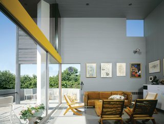 Modernist Angular Residence with Vertical Cedar Siding - Photo 1 of 6 - Inside, the slim cedar boards wrap the walls horizontally, a visual trick that seemingly expands the home’s petite footprint.