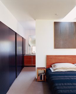 Along one wall of the master bedroom White used Columbia Forest Product’s EcoColors panels (an FSC-certified particleboard) to create sliding closet doors.