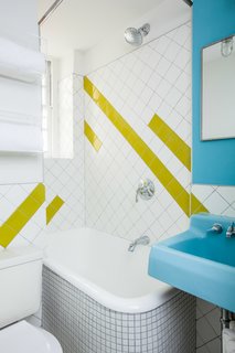 A Gut Renovation Transforms a Tiny Manhattan Apartment - Photo 5 of 8 - A geographic lime-green tile pattern was incorporated into the bathroom to complement the sink, which was found in an architectural salvage yard and retains its original color. Photo by Alan Gastelum.