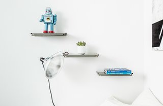 A Gut Renovation Transforms a Tiny Manhattan Apartment - Photo 7 of 8 - The cantilevered shelving in the bedroom was fashioned from vintage metal panels that were purchased online, Davison says. Photo by Alan Gastelum.